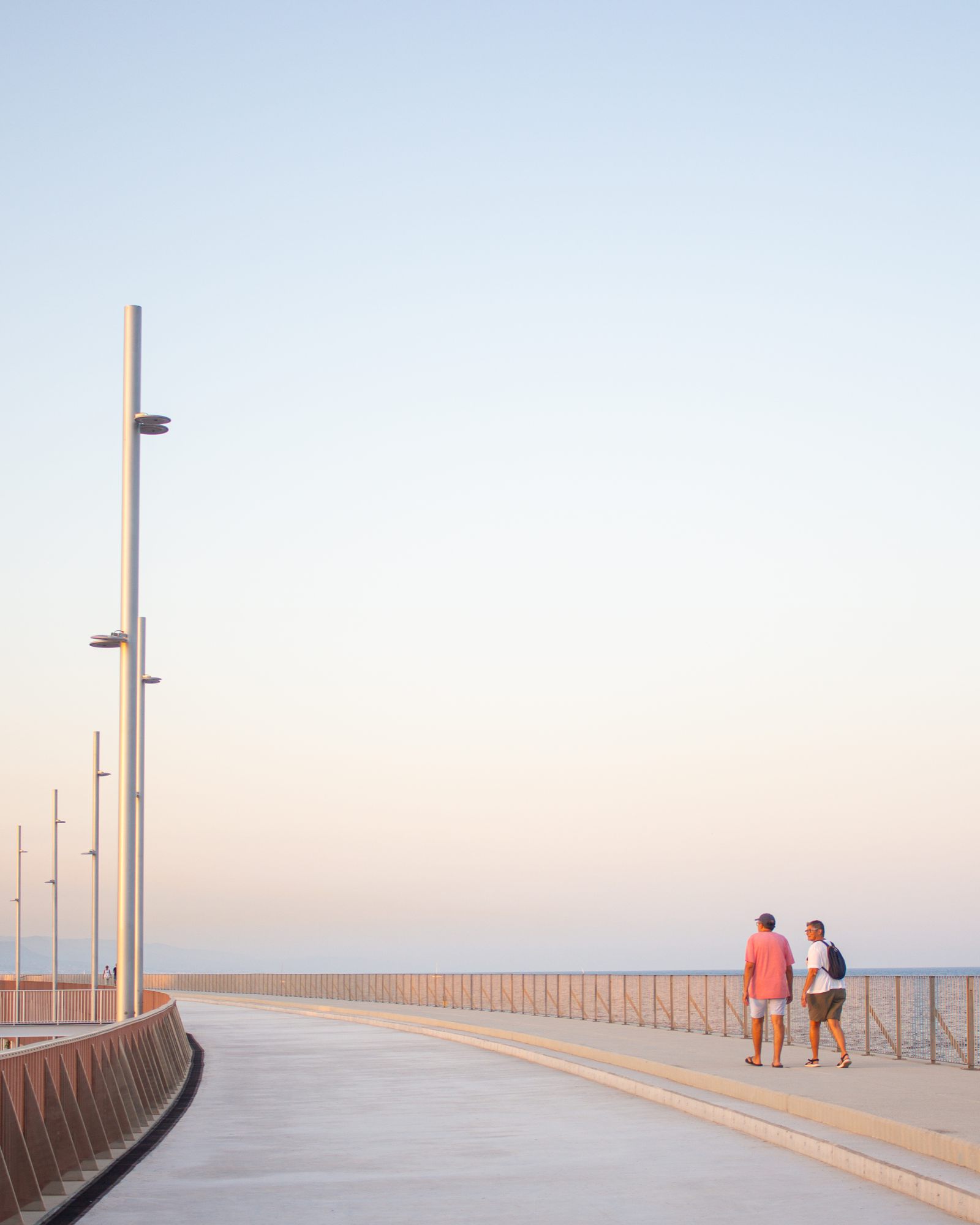 People walking along the breakwater
