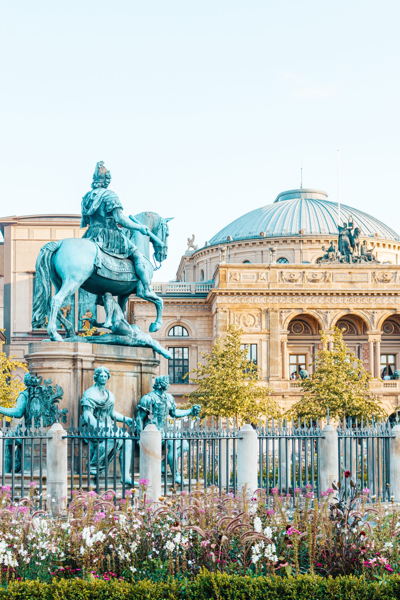 Equestrian statue in front of a domed church