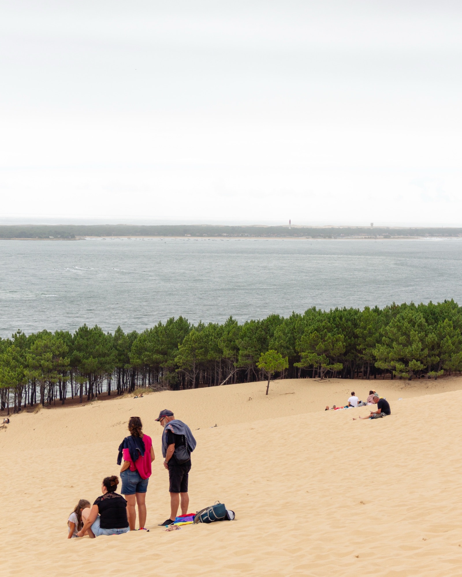 People resting on a sand dune